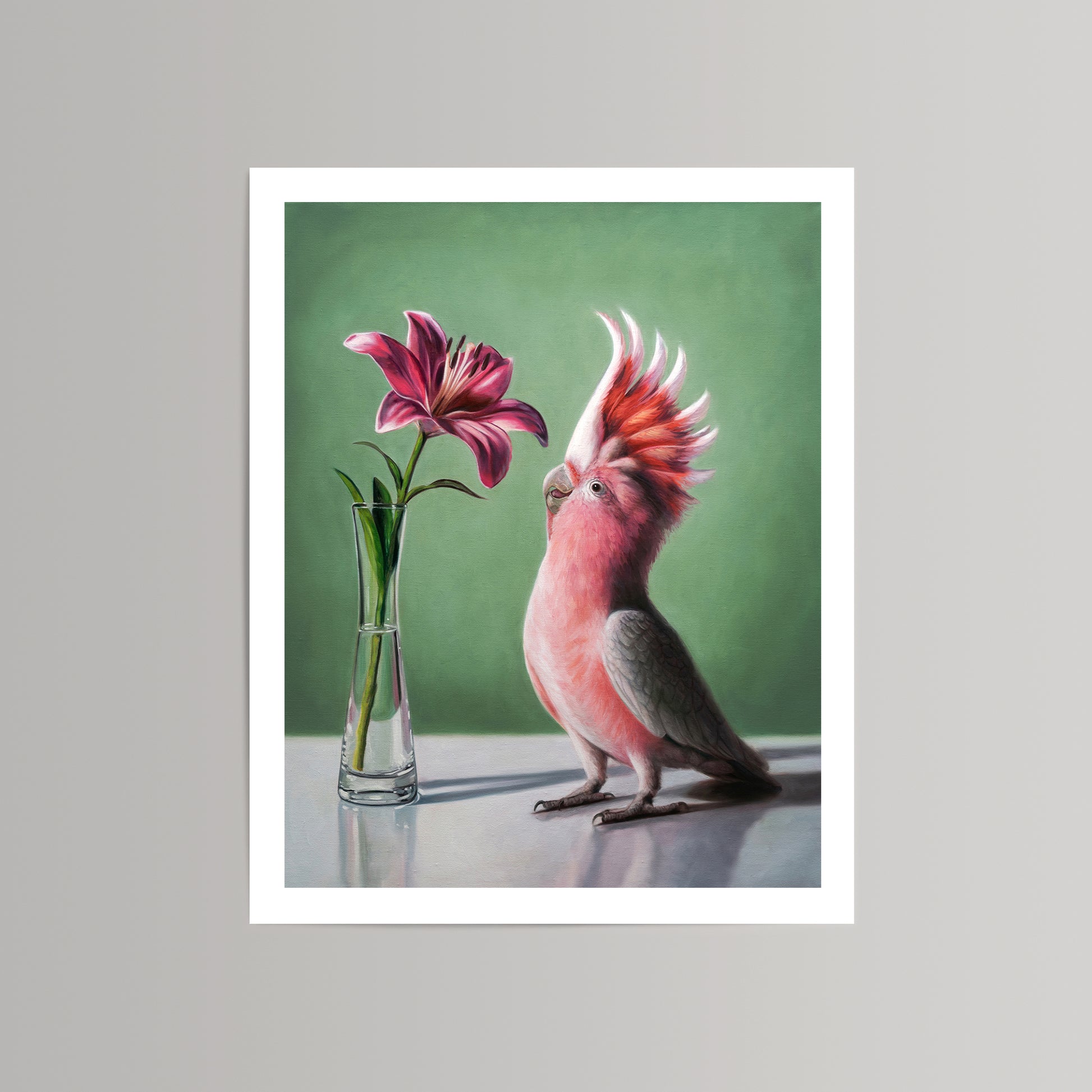 Fine art print of a pink cockatoo admiring a deep pink lily in a clear vase against a green background.