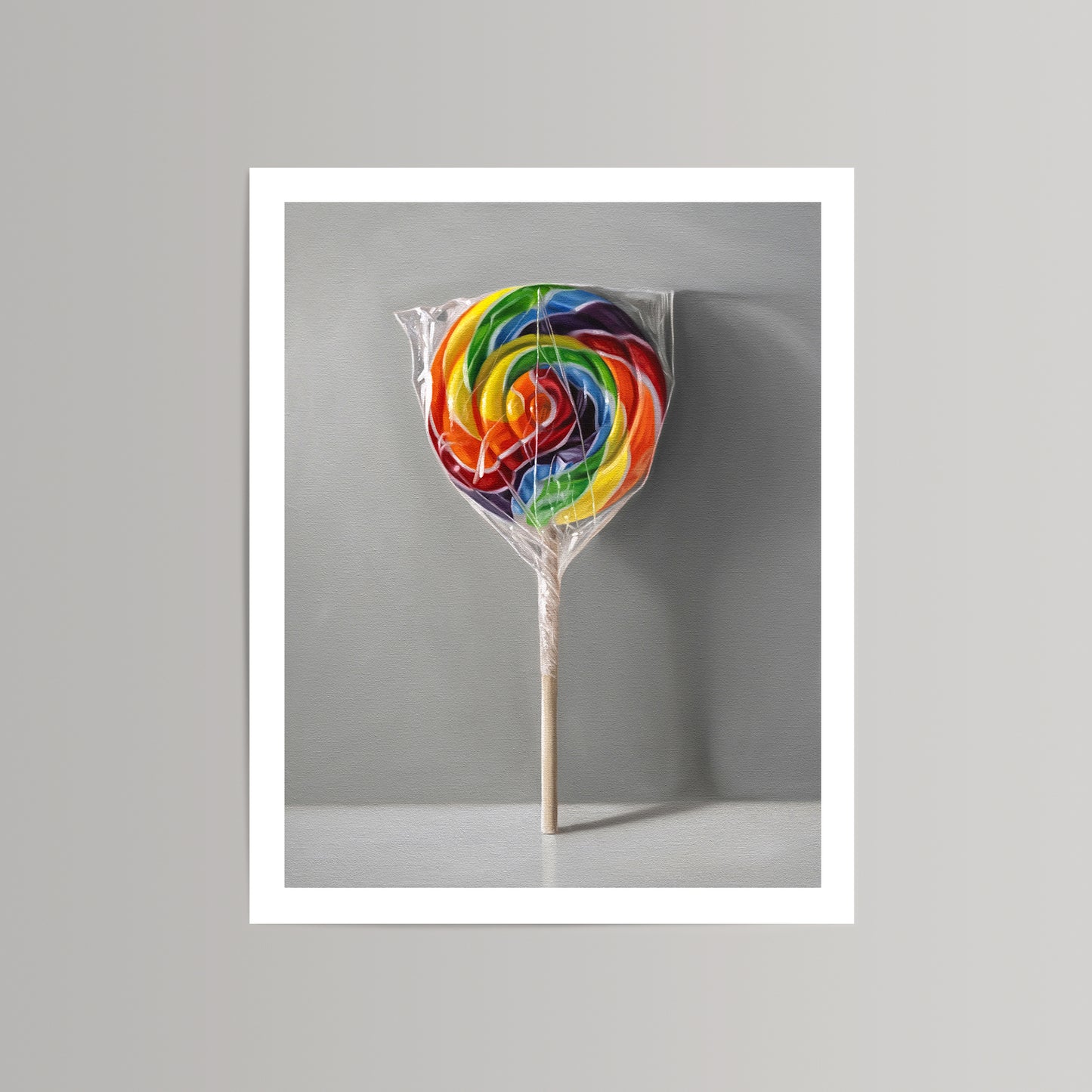 Vibrant rainbow swirl lollipop art print on museum-grade paper, featuring a clear wrapper and wooden stick.