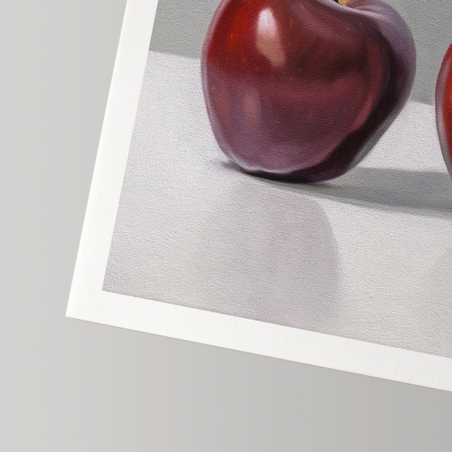 Textured fine art print of a deep red apple, showcasing the cotton rag paper and white border.
