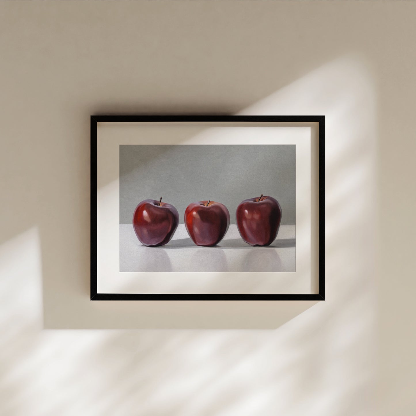 Framed fine art print featuring three vibrant red apples in a realistic, still-life style.
