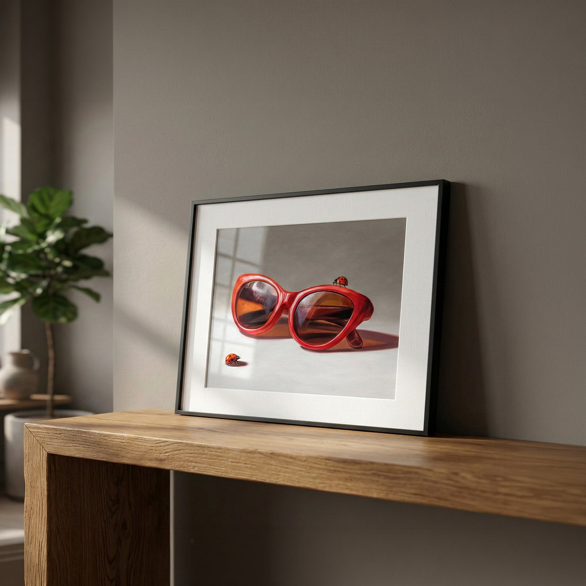 Framed fine art print "Red Ladies Trio" featuring vibrant red sunglasses and ladybugs on museum-grade paper.
