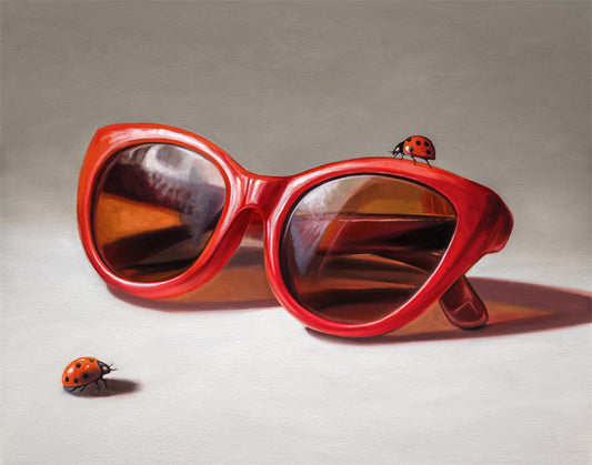 Vibrant red cat-eye sunglasses with two ladybugs on a neutral background, a fine art print.