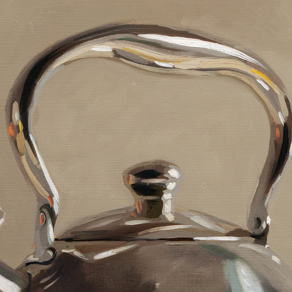 Close-up of a metallic teapot with a brown background