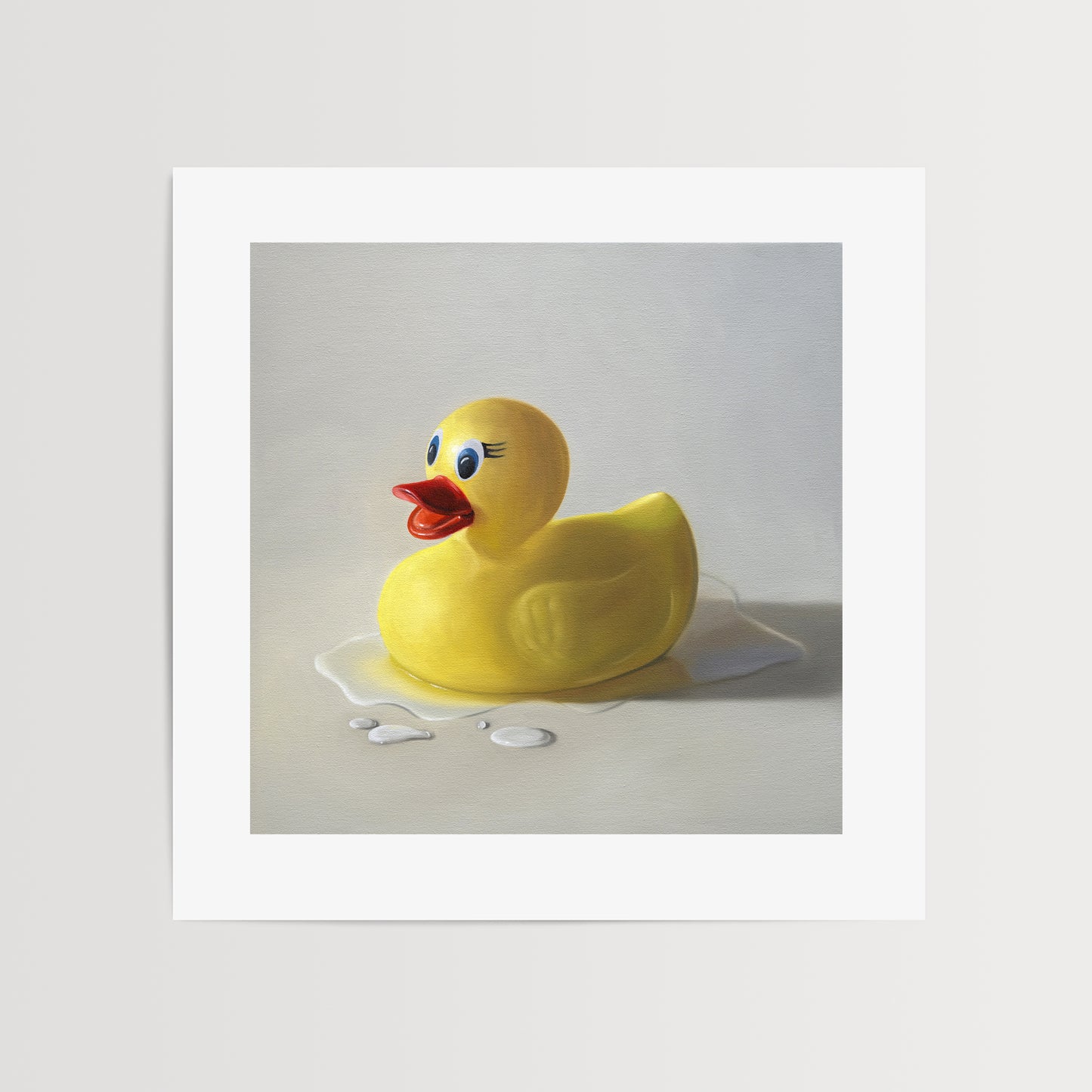 Rubber Ducky Splash Fine Art Print by Lauren Pretorius: a rubber ducky resting on a light surface surrounded by water droplets with some nice dramatic lighting.