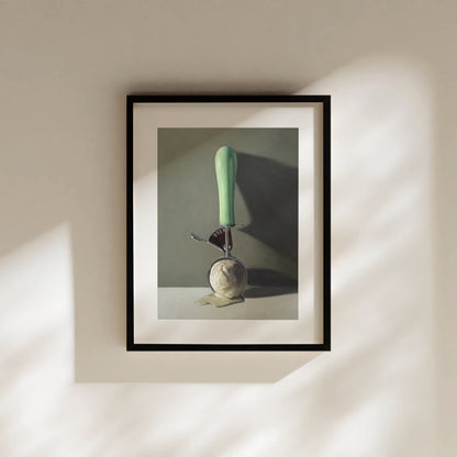 Scoop of Vanilla Fine Art Print by Lauren Pretorius: a vintage ice cream scoop filled with melting vanilla ice cream, set against a softly-lit backdrop of shadows and dramatic lighting.