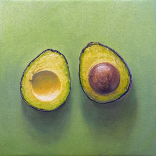 Sliced Avocado Fine Art Print by Lauren Pretorius: a freshly sliced avocado resting on a matching green surface with some nice dramatic lighting.