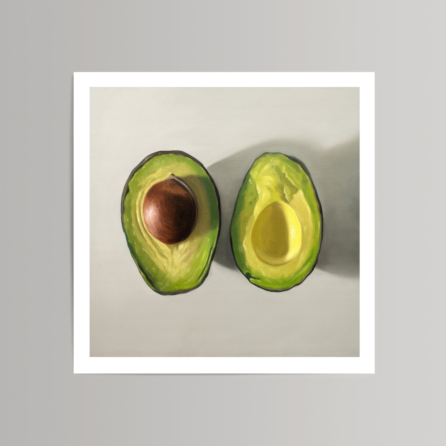 Vibrant art print of two sliced avocados, one with a pit, on a light gray background with a white border.