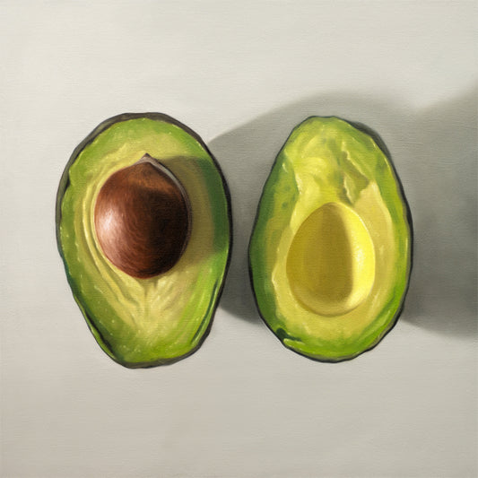 Fine art print of two vibrant green avocado halves, one with a brown pit, on a light background.