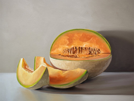 Sliced Cantaloupe Melon Fine Art Print by Lauren Pretorius: a freshly sliced cantaloupe resting on a light grey surface with some nice dramatic lighting.