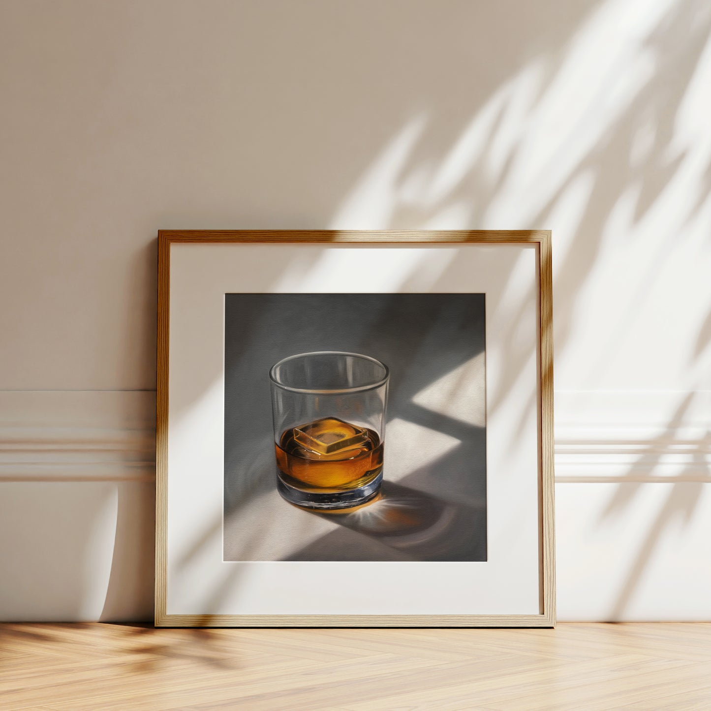 Smooth Whiskey Fine Art Print by Lauren Pretorius: a glass of whiskey with a single clear ice cube resting on a neutral surface with dramatic lighting from a window.