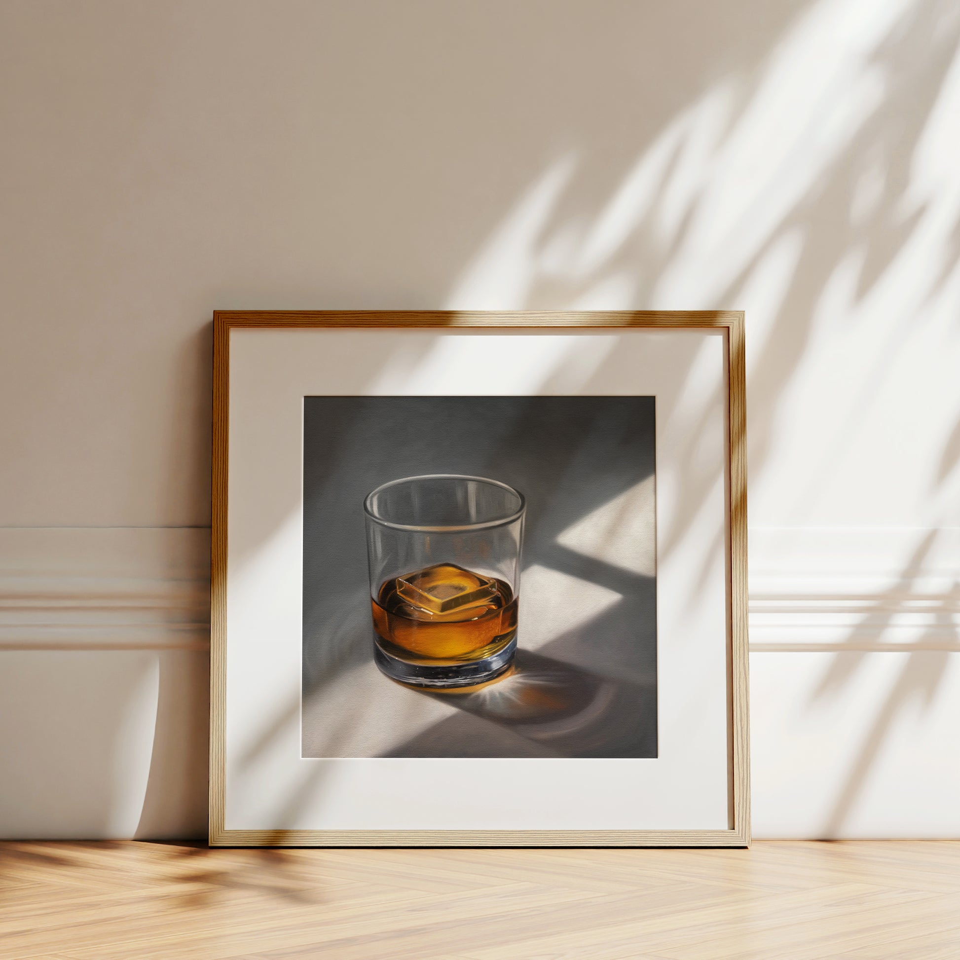 Smooth Whiskey Fine Art Print by Lauren Pretorius: a glass of whiskey with a single clear ice cube resting on a neutral surface with dramatic lighting from a window.