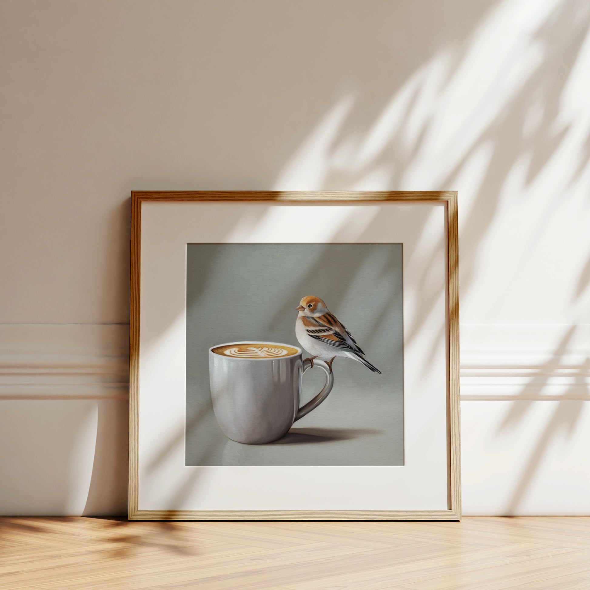 Snow Bunting & Latte Fine Art Print by Lauren Pretorius: a snow bunting perched on the handle of a white cup of coffee.
