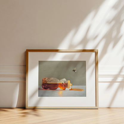 Spilled Honey and Bumble Bee Fine Art Print by Lauren Pretorius: a classic honey bear bottle tipped on its side spilling its contents while a bumble bee hovers above.