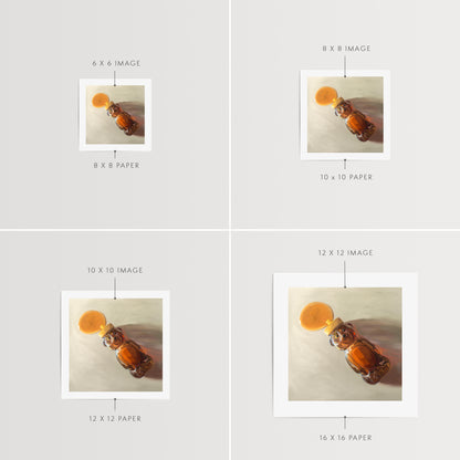 Spilled Honey Fine Art Print by Lauren Pretorius: a honey bear bottle that has tipped over and spilling its contents.