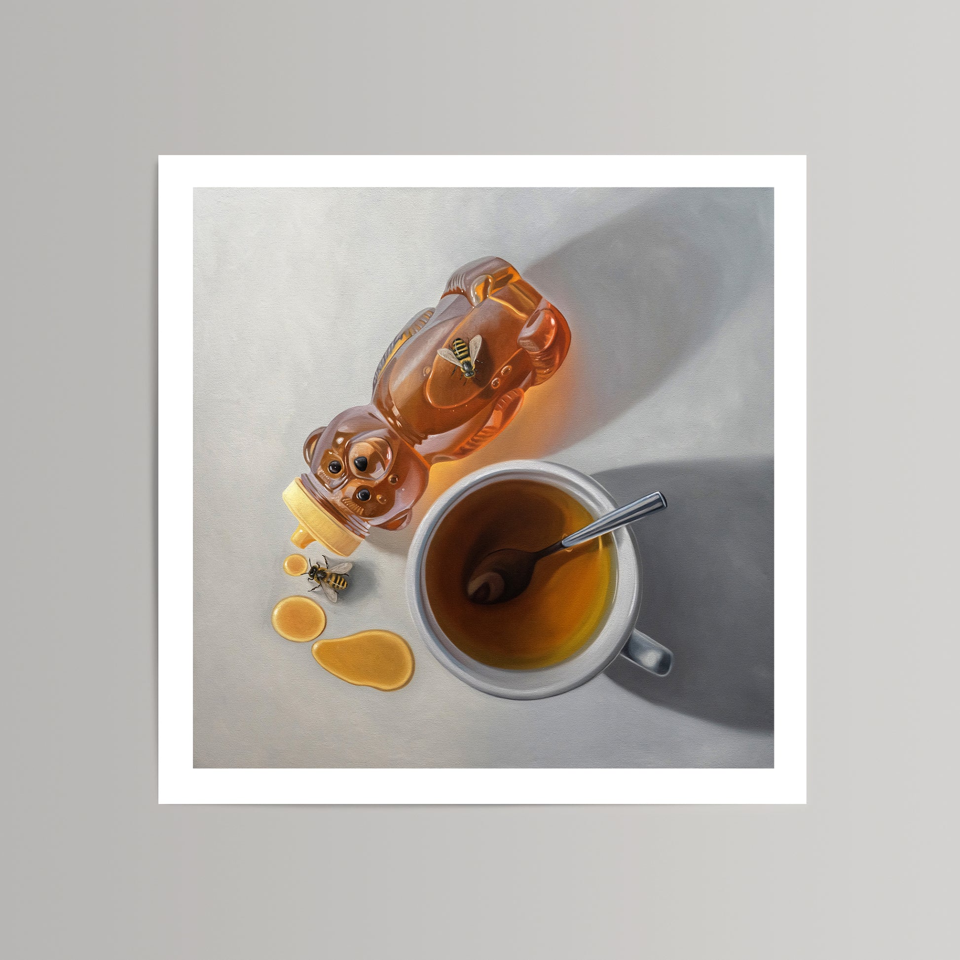 Fine art print of a honey bear bottle spilling golden honey with bees, next to a cup of tea with a spoon.