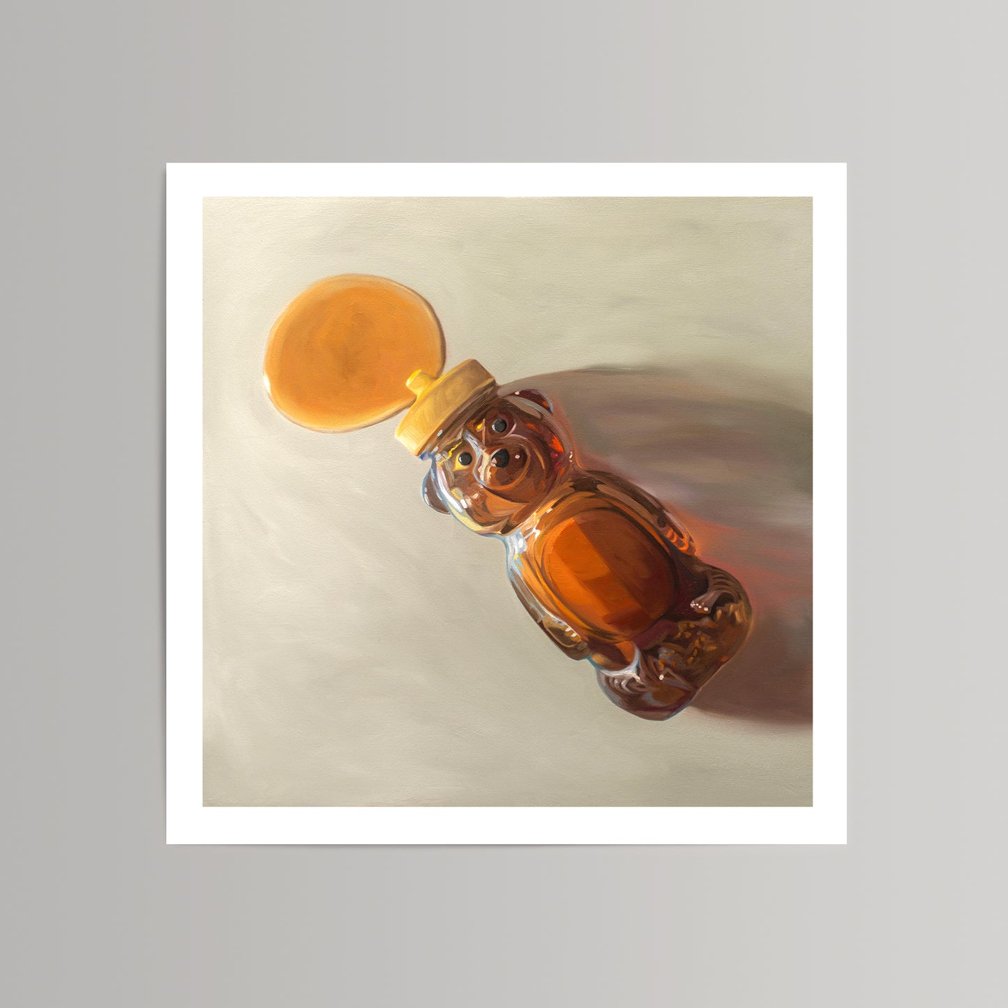 Fine art print of a honey bear bottle spilling golden honey onto a light background.