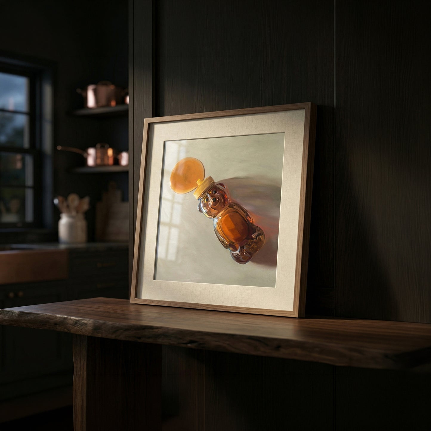 Framed fine art print of a honey bear bottle spilling golden honey, displayed on a dark wooden shelf.