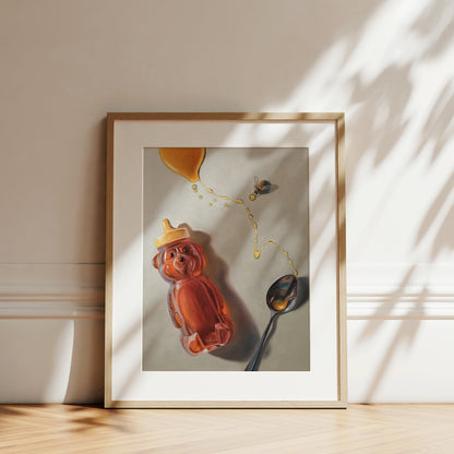 Spilled Honey, Spoon & Bee Fine Art Print by Lauren Pretorius: a bear-shaped honey container, a spoon, and a bee with spilled honey elements, printed on matte archival fine art paper.
