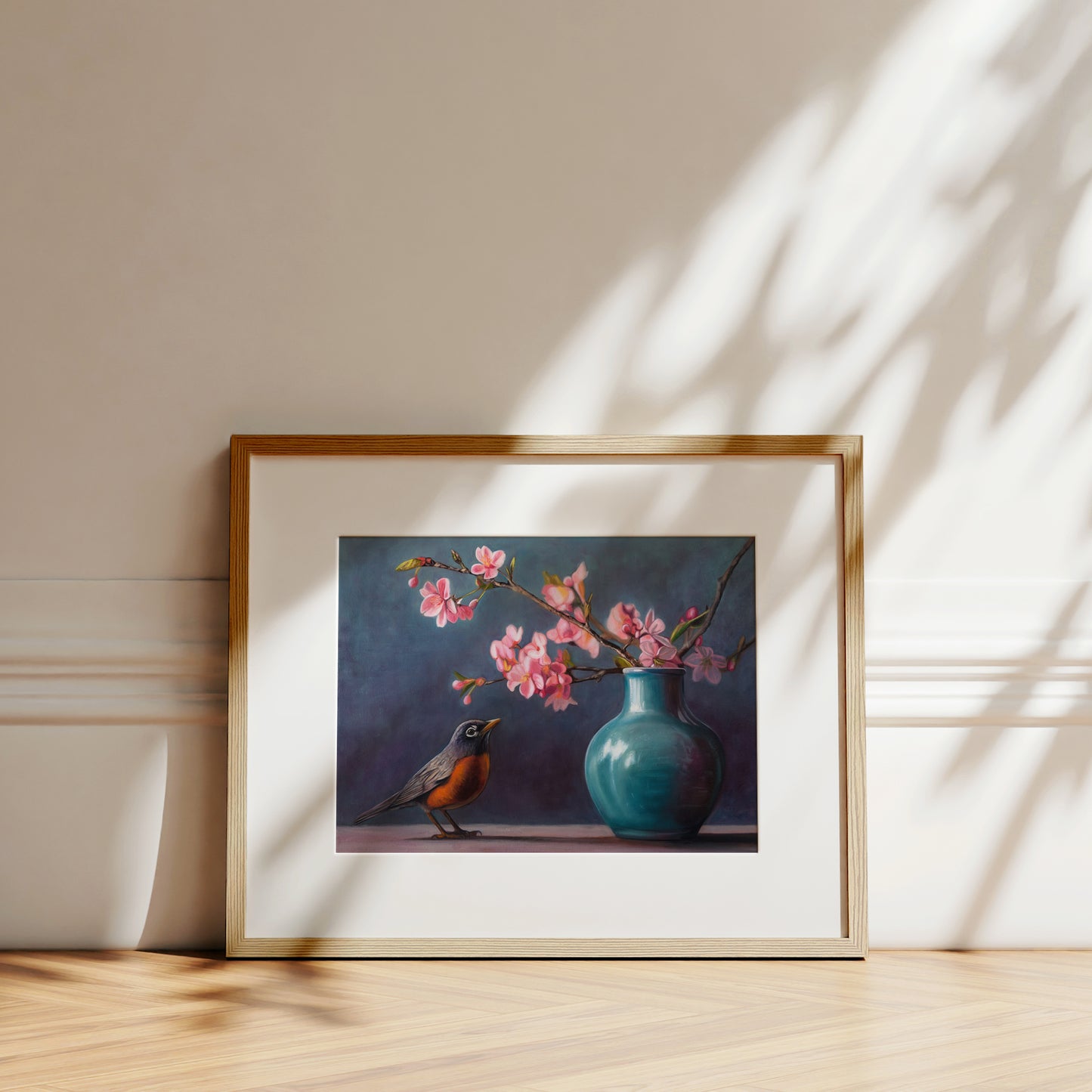 Spring Robin Fine Art Print by Lauren Pretorius: a robin perched next to a vase with pink cherry blossoms against a dark background.