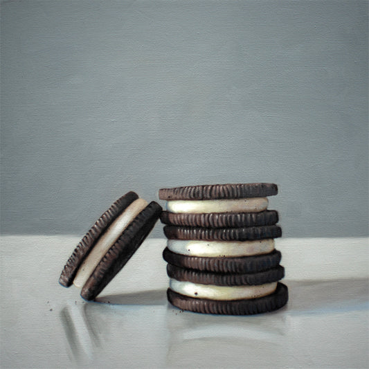 Stack of Cookies Fine Art Print by Lauren Pretorius: a trio of Oreos on a light, reflective surface with dramatic lighting and cast shadows.