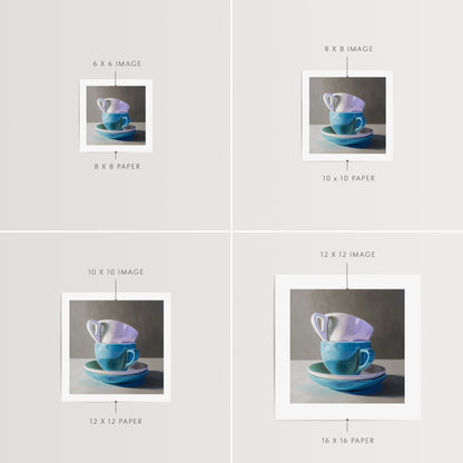 Stacked Cups & Saucers Fine Art Print by Lauren Pretorius: a stack of blue and white cups and saucers on a table.