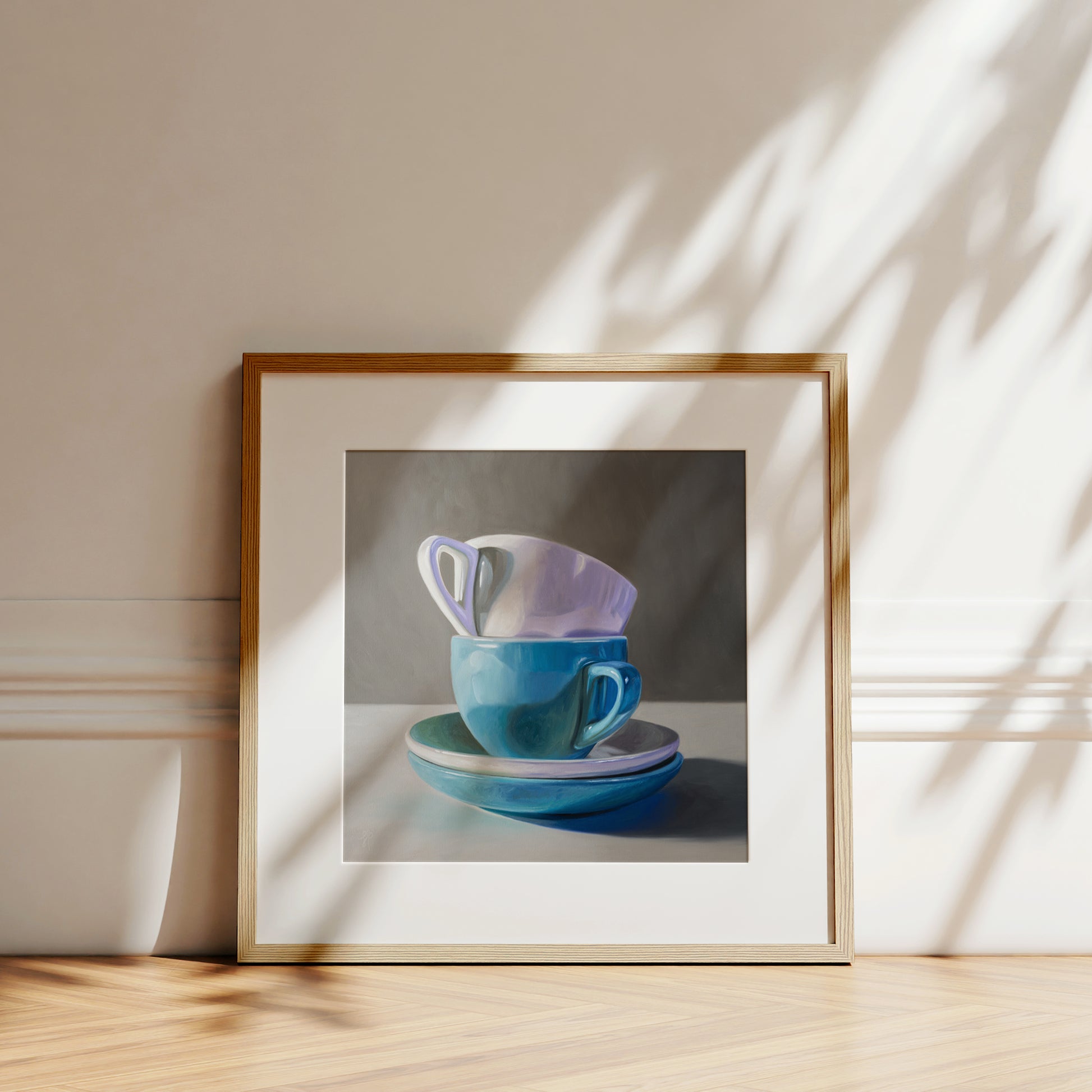 Stacked Cups & Saucers Fine Art Print by Lauren Pretorius: a stack of blue and white cups and saucers on a table.