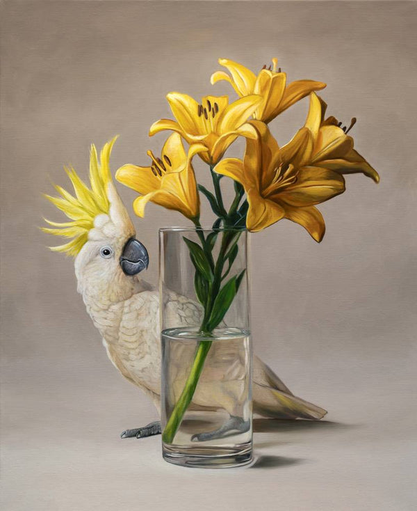 White cockatoo with yellow feathers next to a clear vase with yellow lilies on a neutral background