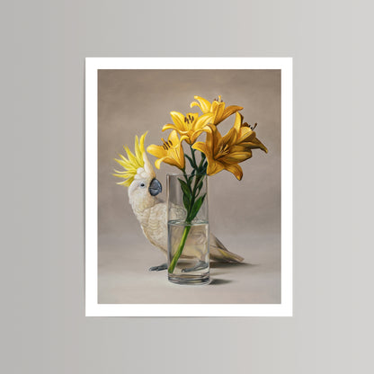 Fine art print of a white sulphur-crested cockatoo next to a vase of vibrant yellow lilies.
