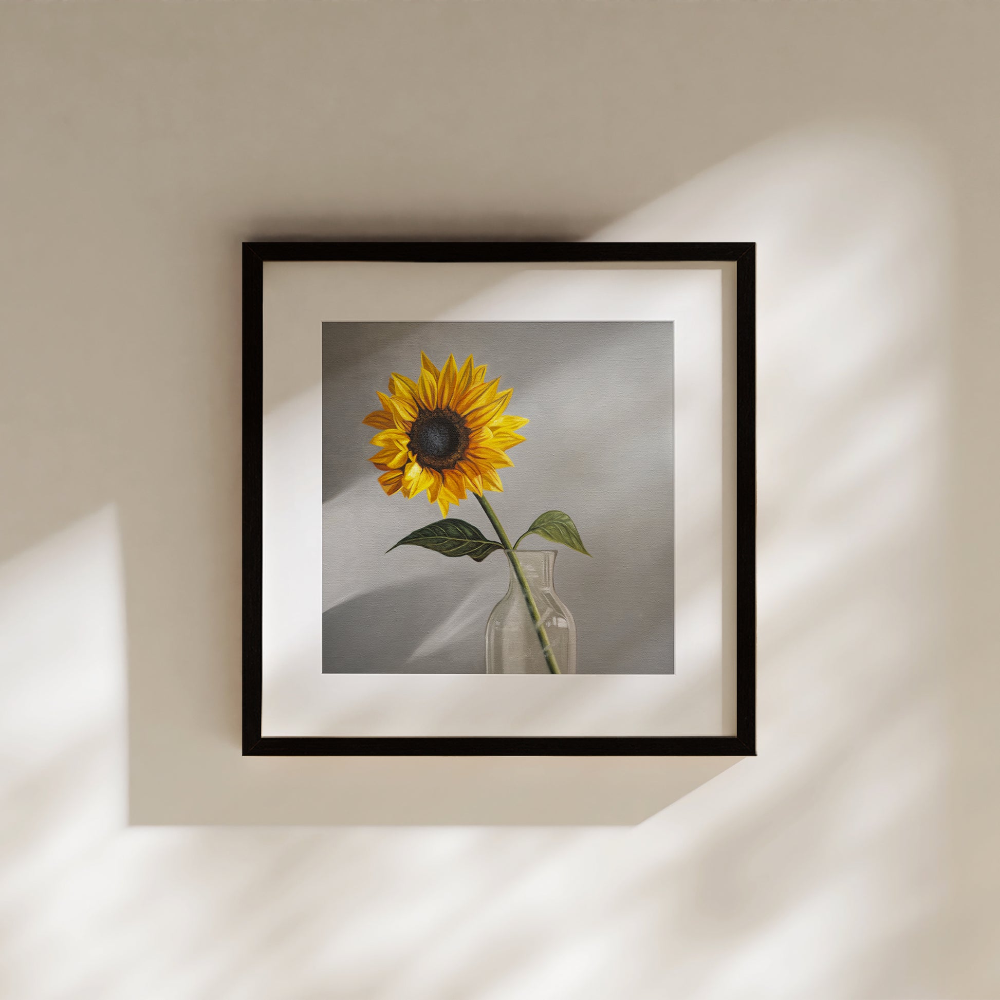 Sunflower Fine Art Print by Lauren Pretorius: a sunflower in a clear glass vase with a neutral grey backdrop.