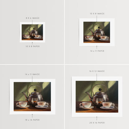 Tea for Two Fine Art Print by Lauren Pretorius: a silver tea kettle with a lid, placed on a table with two cups of tea in front. The background is in shadow with a hint of light.