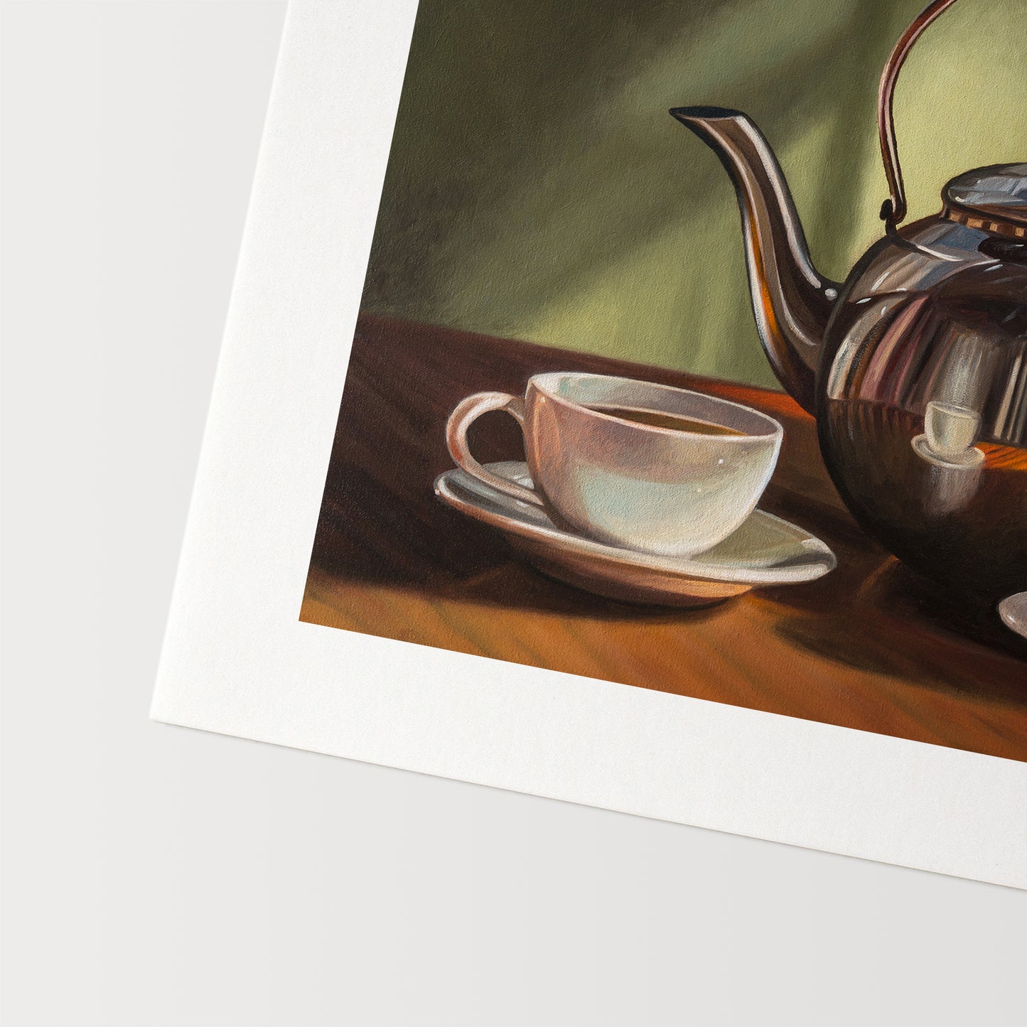 Tea for Two Fine Art Print by Lauren Pretorius: a silver tea kettle with a lid, placed on a table with two cups of tea in front. The background is in shadow with a hint of light.