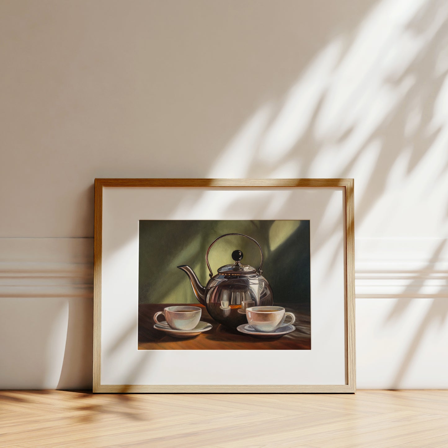 Tea for Two Fine Art Print by Lauren Pretorius: a silver tea kettle with a lid, placed on a table with two cups of tea in front. The background is in shadow with a hint of light.