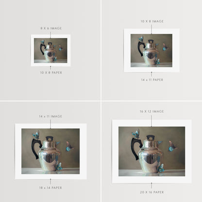 Tea Kettle and Blue Butterflies Fine Art Print by Lauren Pretorius: a trio of blue butterflies surrounding a vintage tea kettle.is from a series tea kettles paired with various objects.