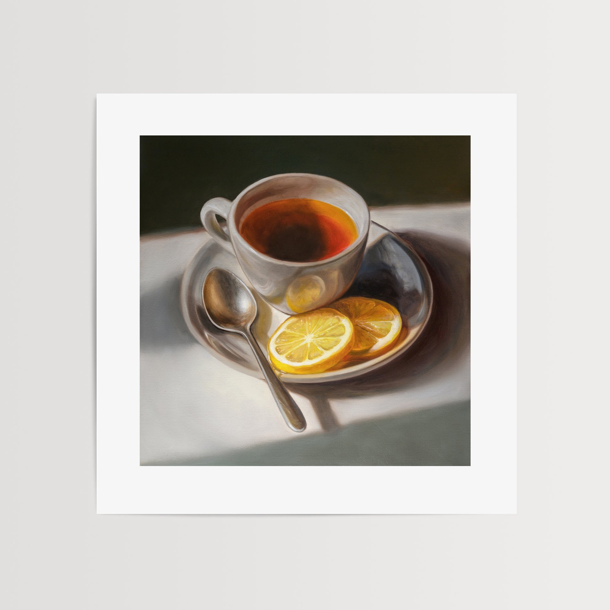 Tea with Lemons Fine Art Print by Lauren Pretorius: a cup of tea with lemon slices on a plate, accompanied by a spoon, against a light background.