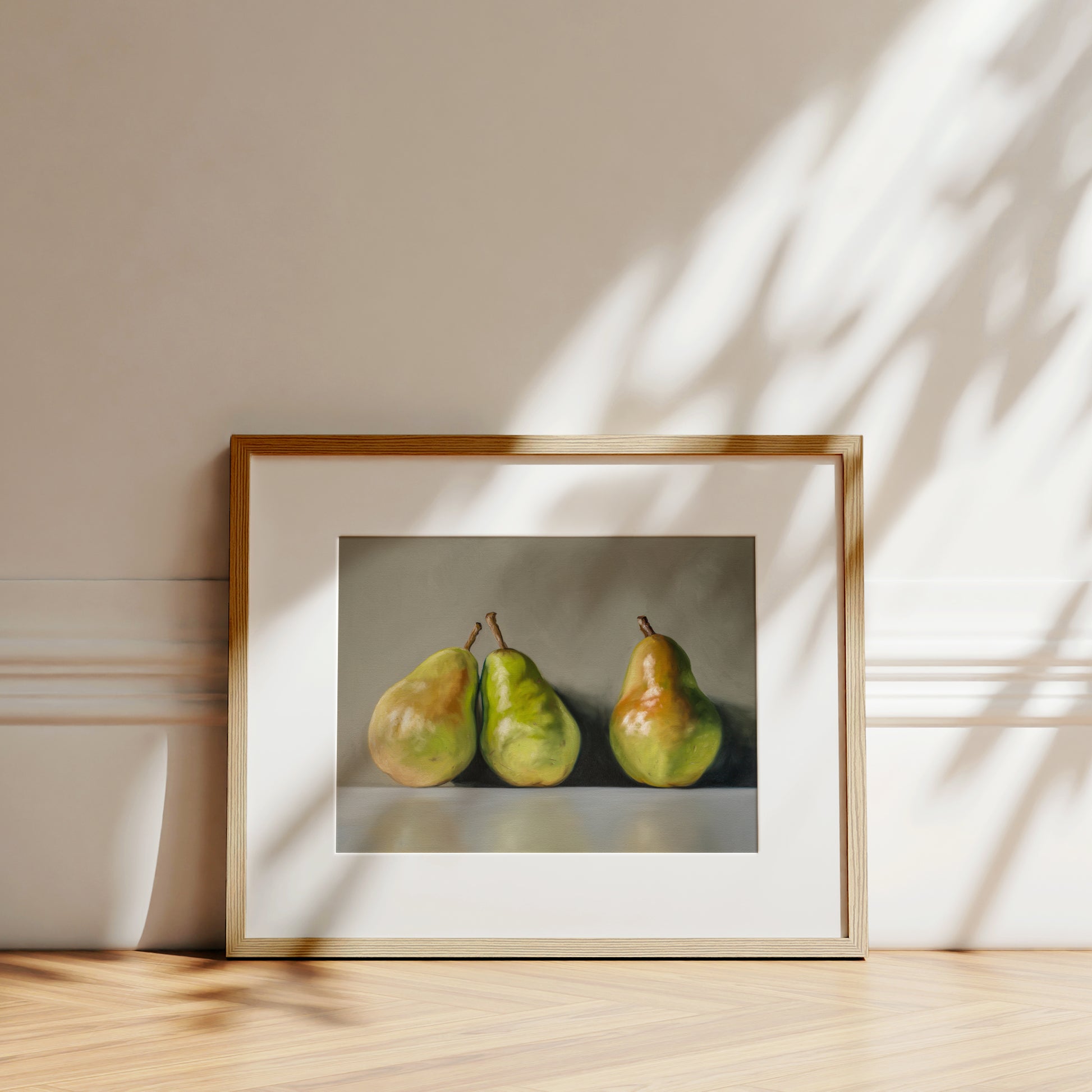 Three Pears Fine Art Print by Lauren Pretorius: three green pears with brown stems on a reflective surface and gray background
