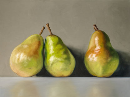 Three Pears Fine Art Print by Lauren Pretorius: three green pears with brown stems on a reflective surface and gray background
