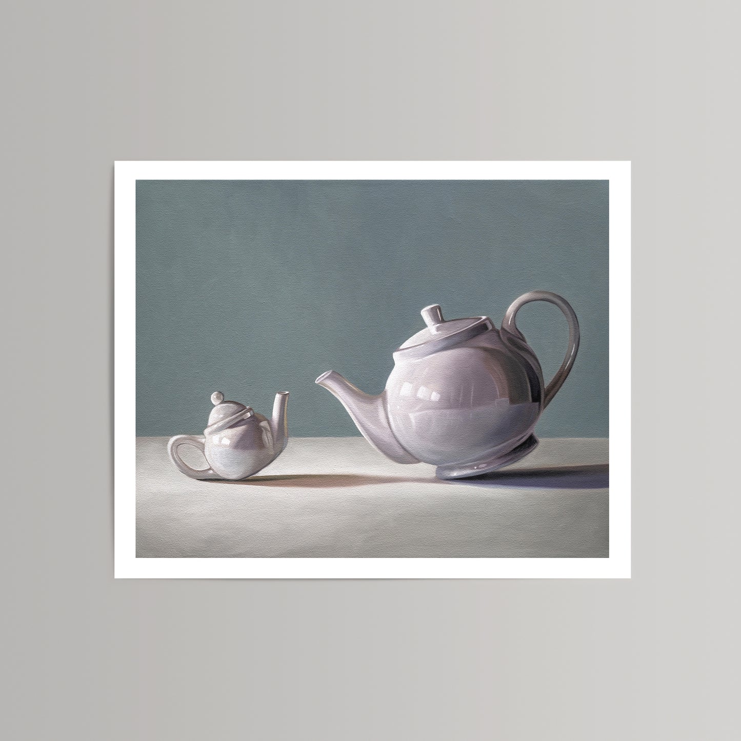 Still life art print featuring a large and small white ceramic teapot on a light surface against a grey-blue background.