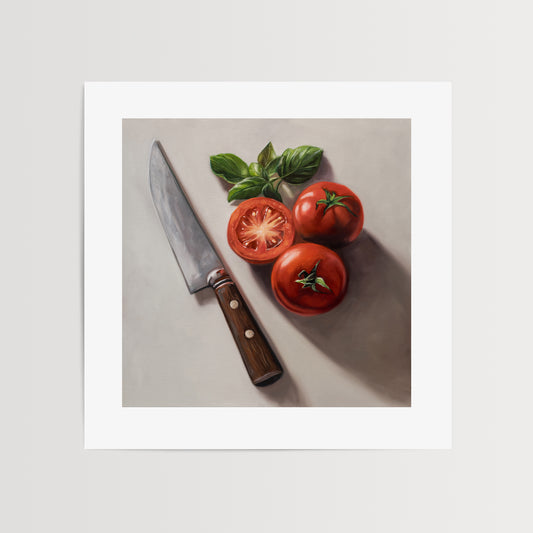 Tomato & Basil Fine Art Print by Lauren Pretorius: a knife next to three tomatoes and basil leaves on a light surface