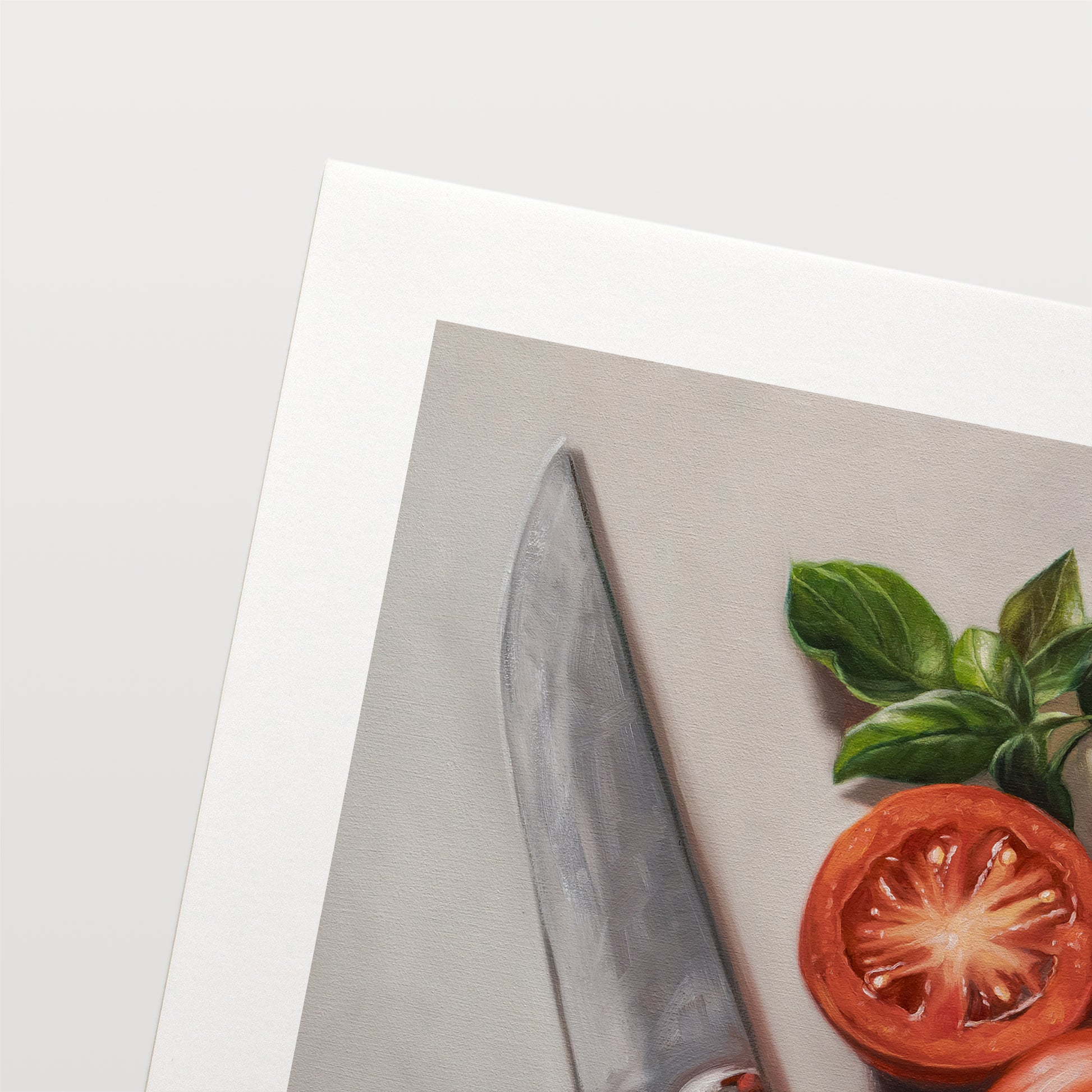 Tomato & Basil Fine Art Print by Lauren Pretorius: a knife next to three tomatoes and basil leaves on a light surface