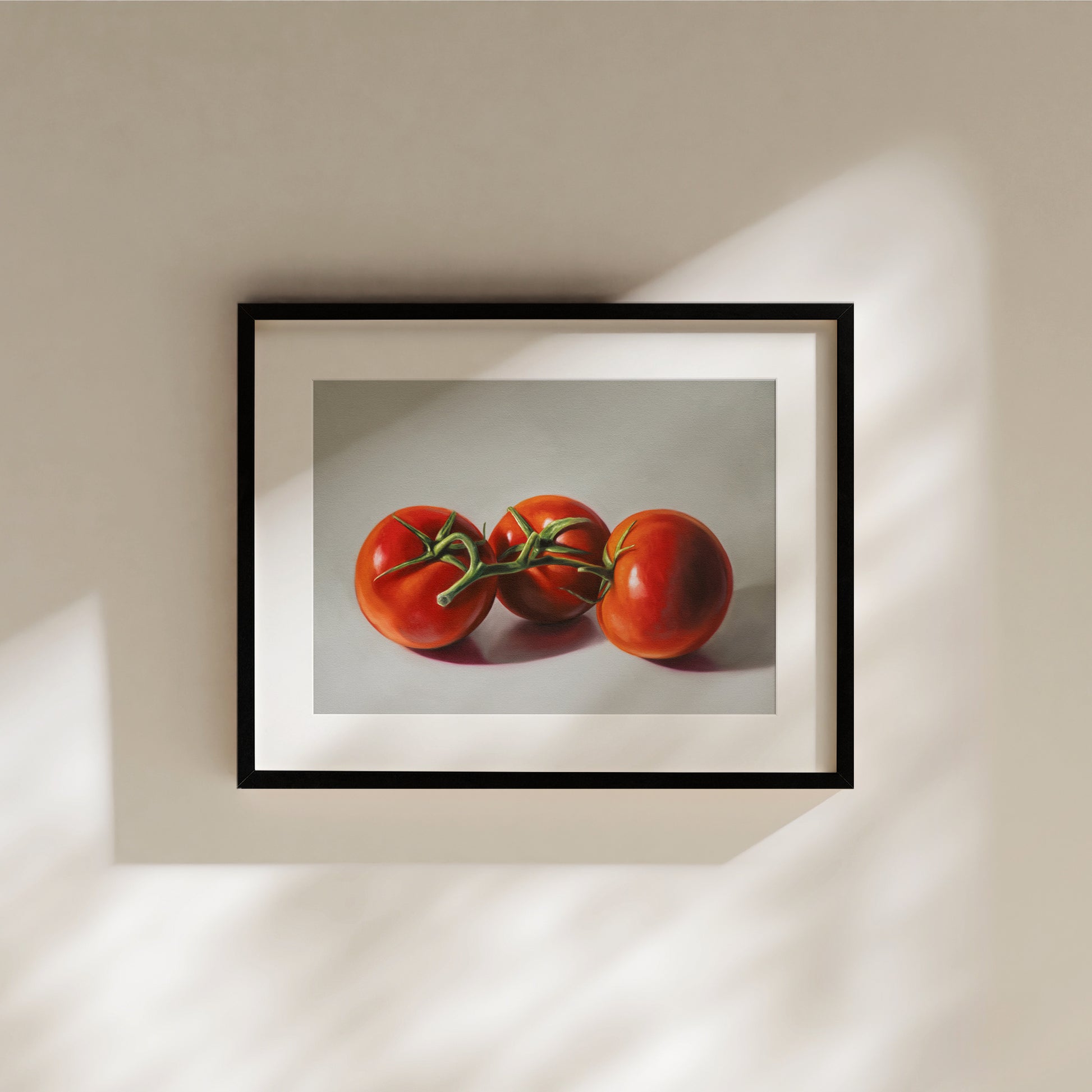 Framed fine art print of three vibrant red tomatoes on a vine, with a white border.