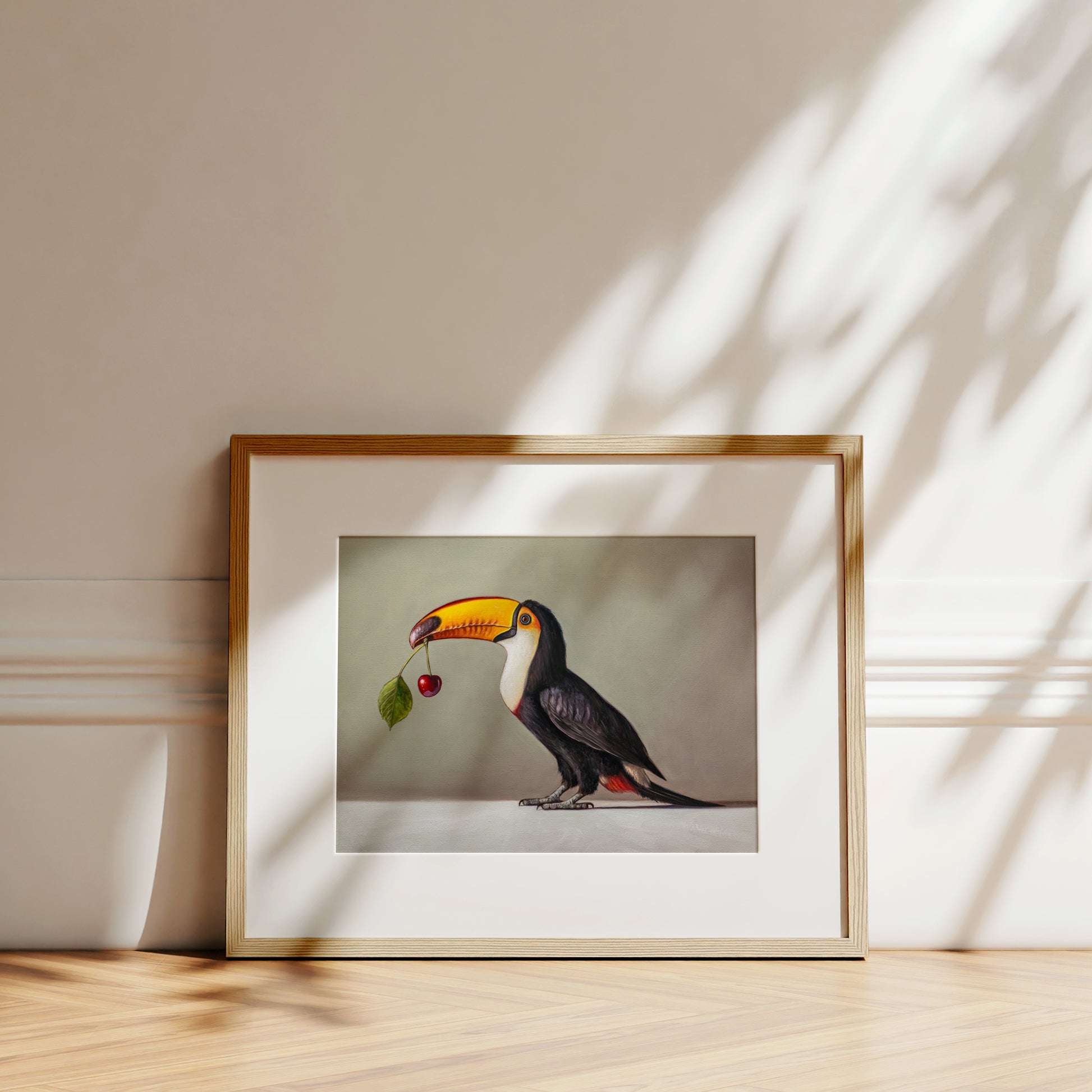 Toucan & Cherry Fine Art Print by Lauren Pretorius: a toucan with a cherry, black, white, and red colors with a gray background.
