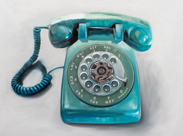 Vintage turquoise rotary phone on a light gray background