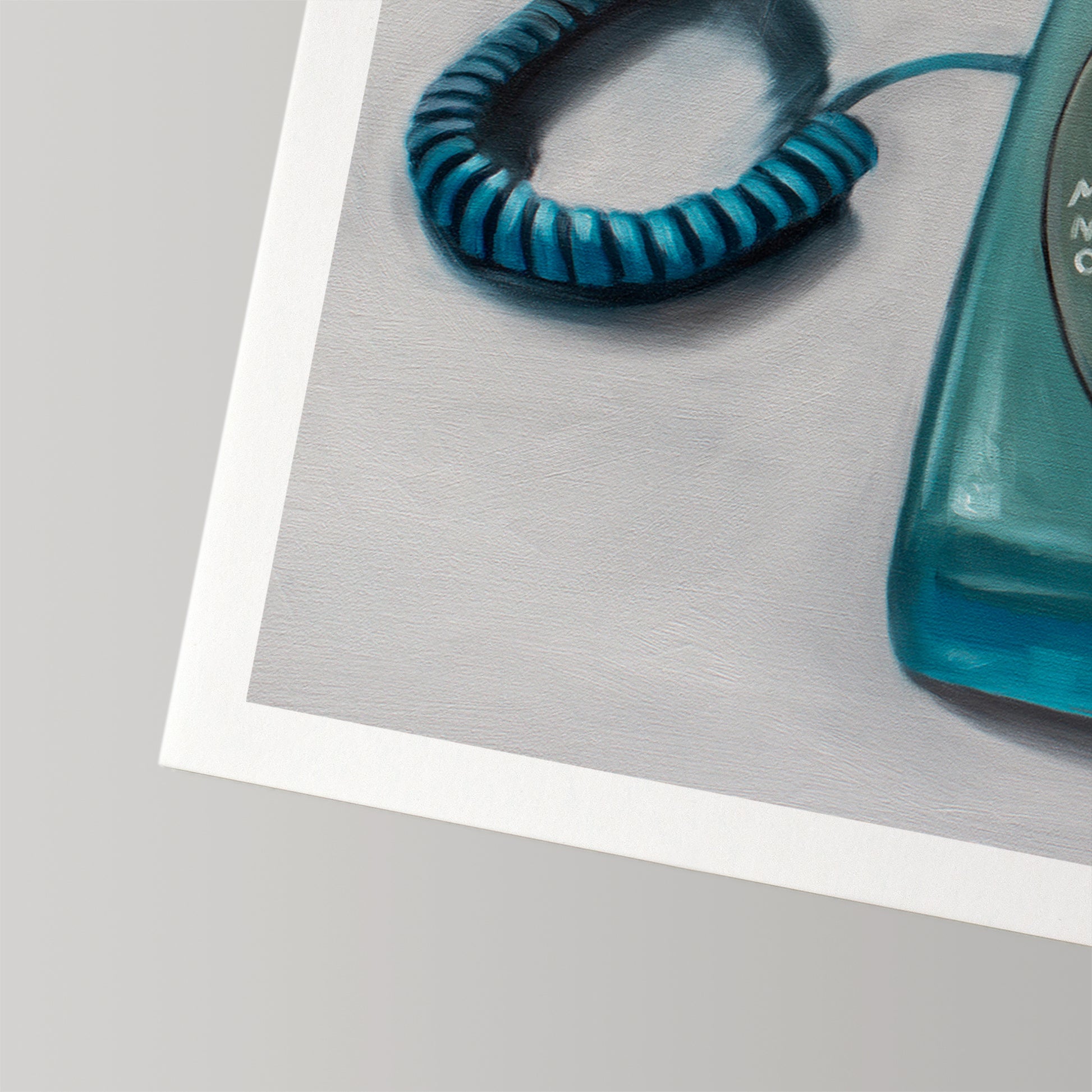 Fine art print of a vintage turquoise rotary telephone with a coiled cord on a gray background.