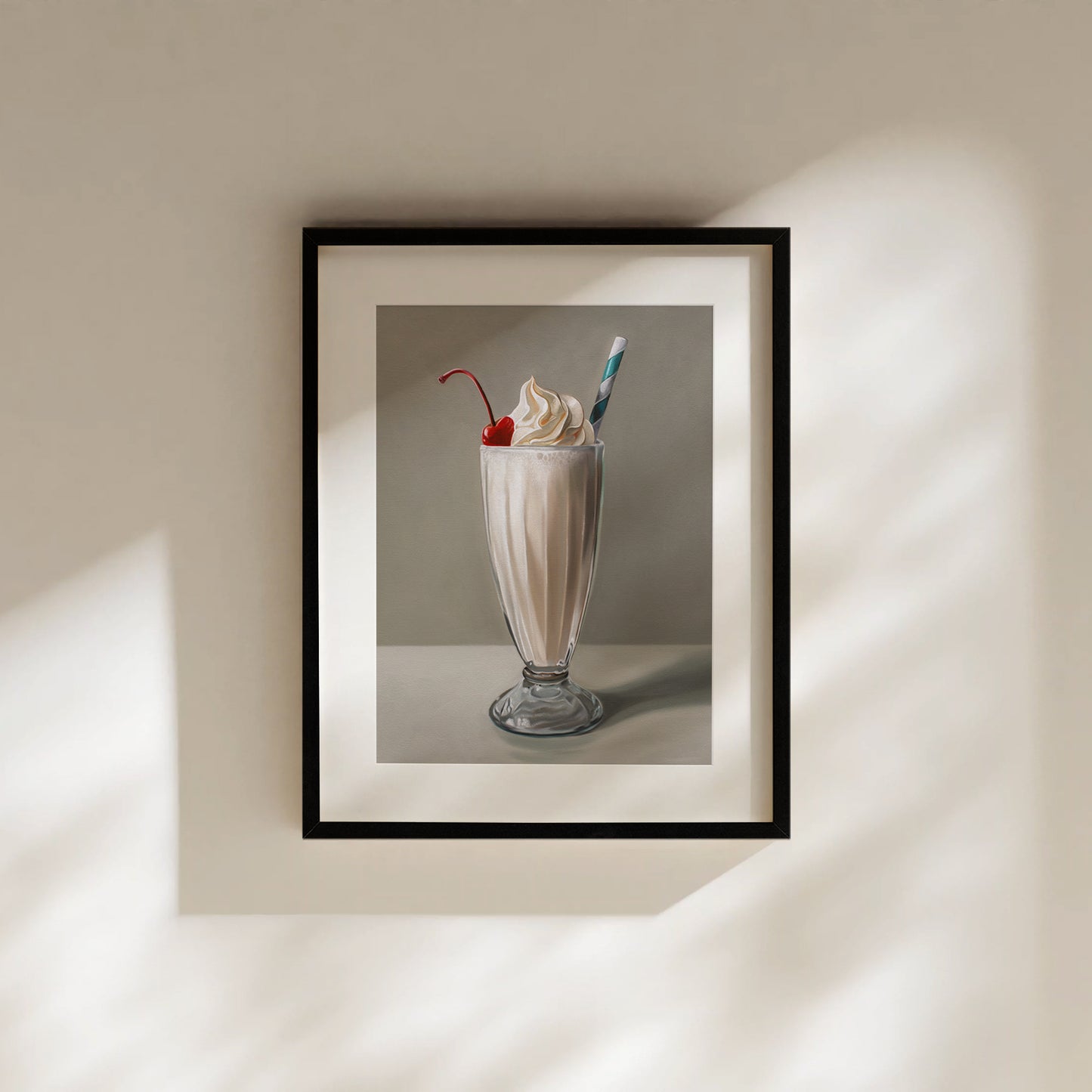Framed fine art print of a vanilla milkshake with whipped cream, a cherry, and a striped straw.