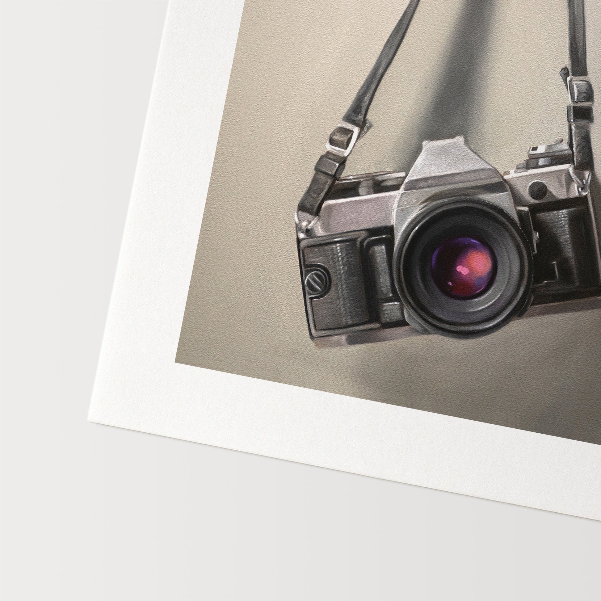 Vintage Film Camera Fine Art Print by Lauren Pretorius: a vintage 35mm camera hanging from its strap with some nice dramatic lighting.