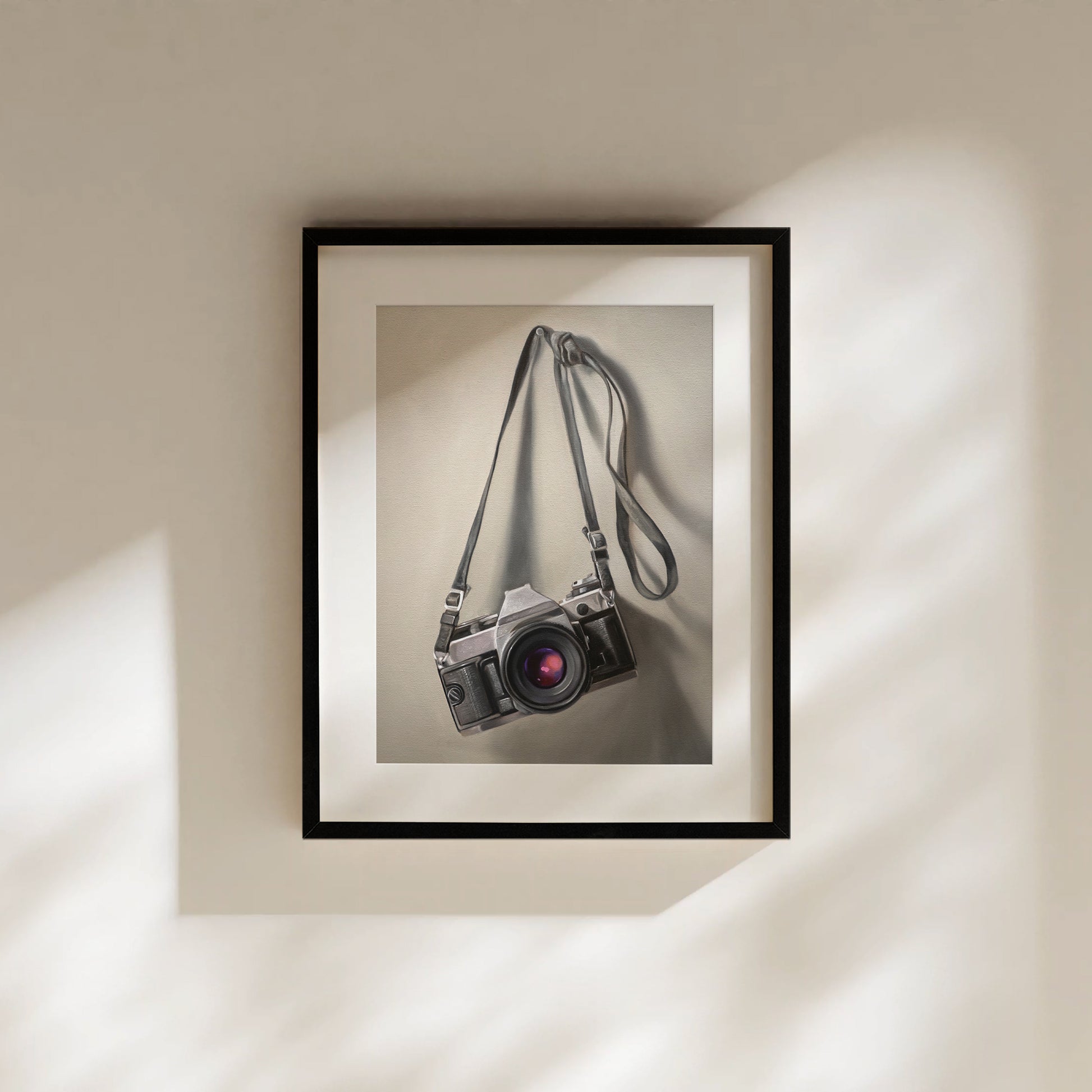 Vintage Film Camera Fine Art Print by Lauren Pretorius: a vintage 35mm camera hanging from its strap with some nice dramatic lighting.