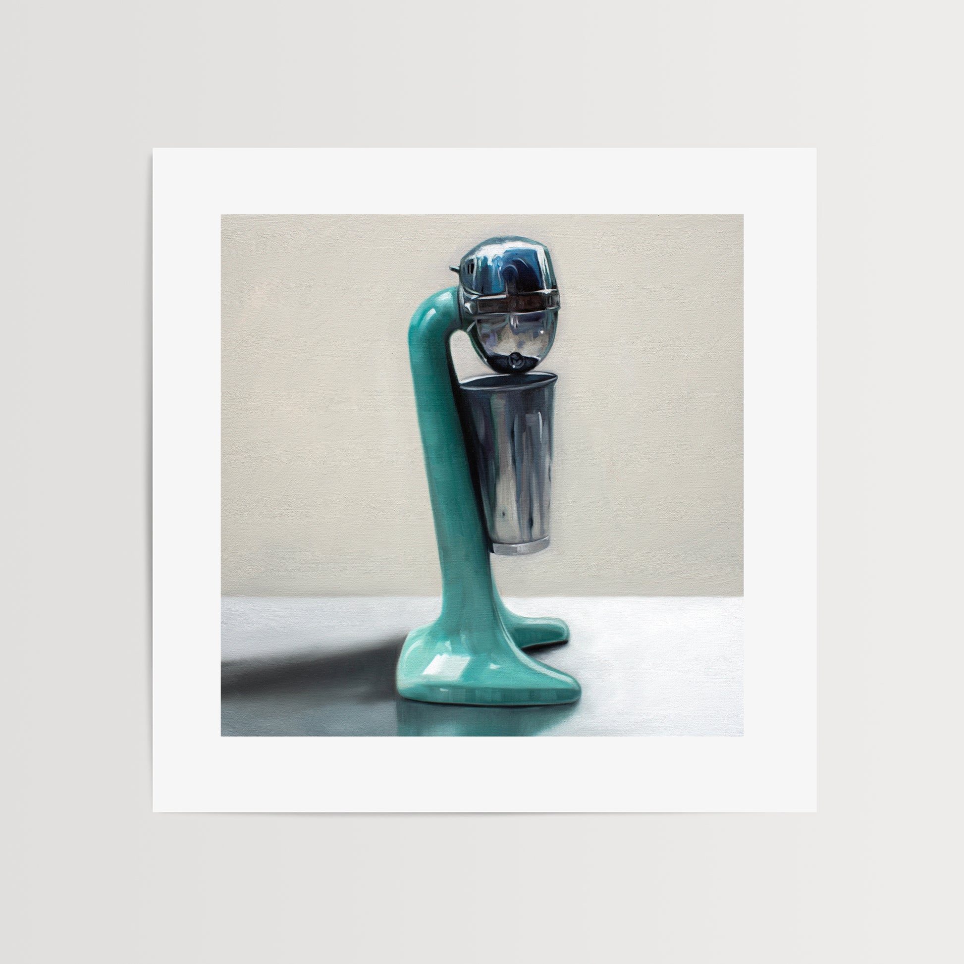 Vintage Milkshake Mixer Fine Art Print by Lauren Pretorius: a vintage turquoise milkshake mixer resting on a light reflective surface and grey background.