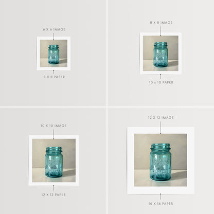 Vintage Turquoise Jar Fine Art Print by Lauren Pretorius: a classic vintage blue glass jar on a light reflective surface.