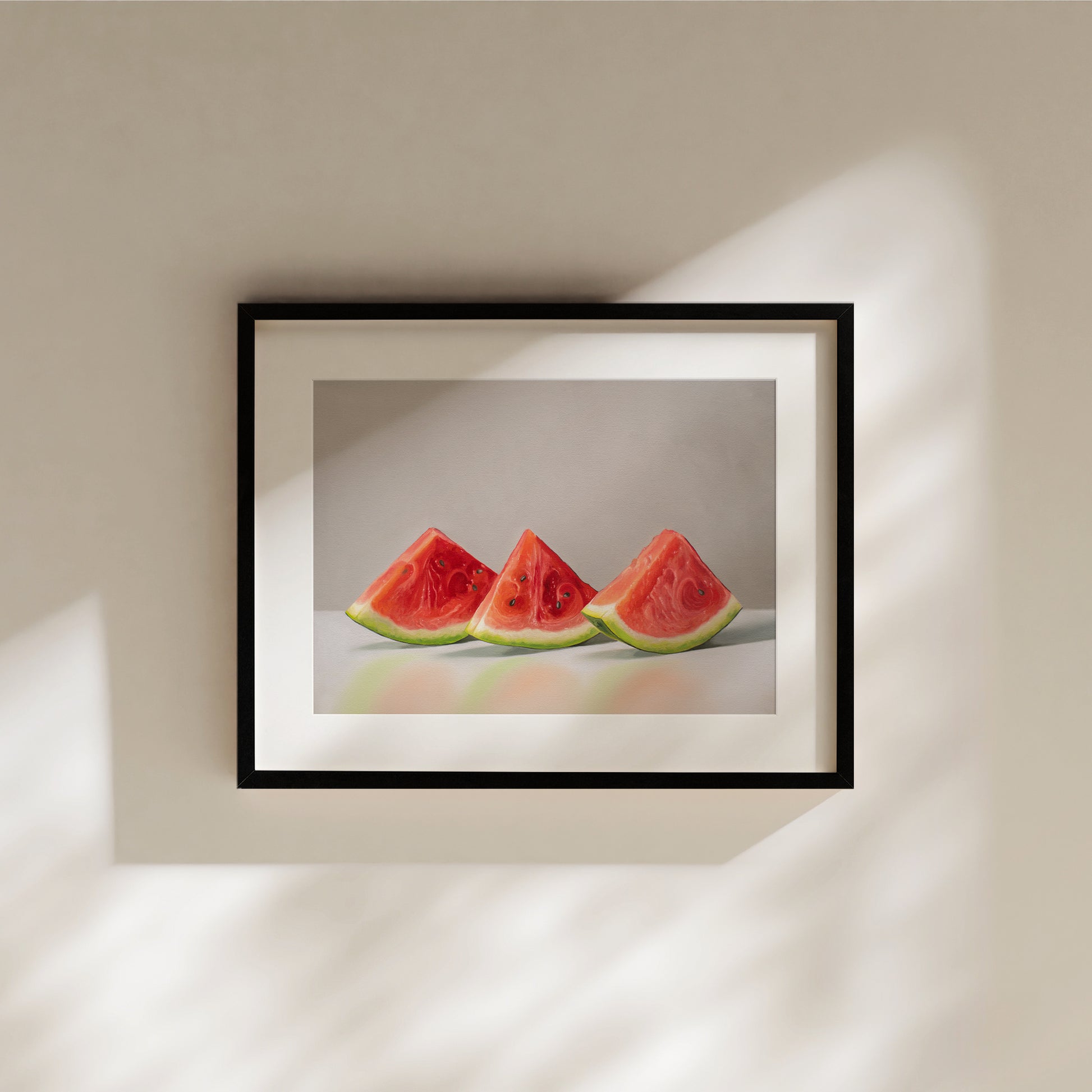Framed fine art print of three vibrant red watermelon slices with green rinds on a light background.