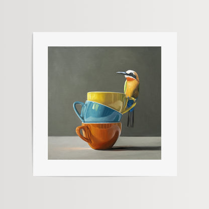 White Fronted Bee Eater & Rainbow Cups Fine Art Print by Lauren Pretorius: a White Fronted Bee Eater perched on top of a stack of colorful coffee cups.